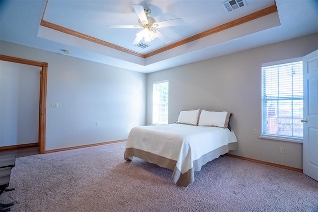 bedroom featuring carpet flooring, a raised ceiling, ceiling fan, and crown molding