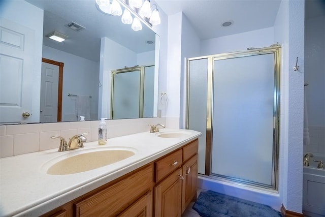 bathroom featuring tasteful backsplash, vanity, and walk in shower