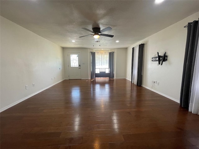 spare room with ceiling fan and dark wood-type flooring