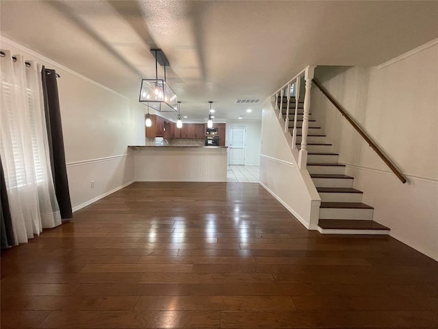 interior space featuring dark hardwood / wood-style flooring and ornamental molding