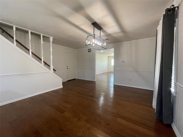 unfurnished dining area featuring crown molding and dark wood-type flooring