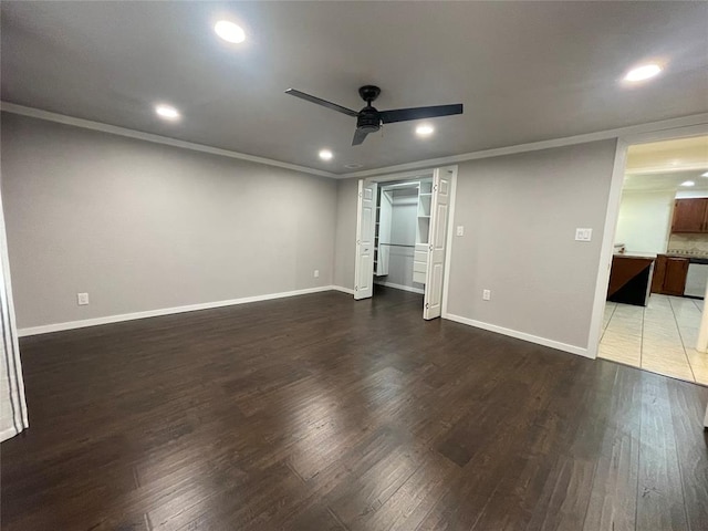 empty room featuring ceiling fan, dark hardwood / wood-style flooring, and crown molding