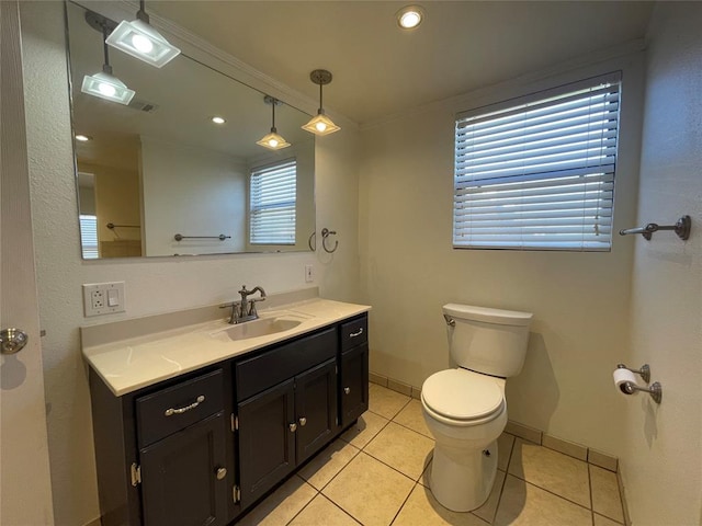 bathroom with tile patterned flooring, plenty of natural light, toilet, and vanity