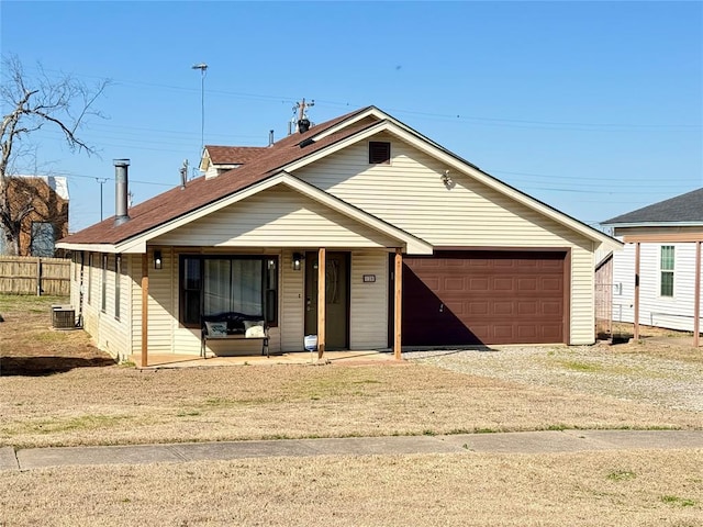 view of front of home with central AC, a garage, fence, and dirt driveway