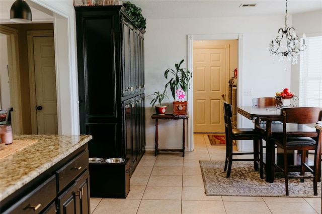 tiled dining area featuring an inviting chandelier