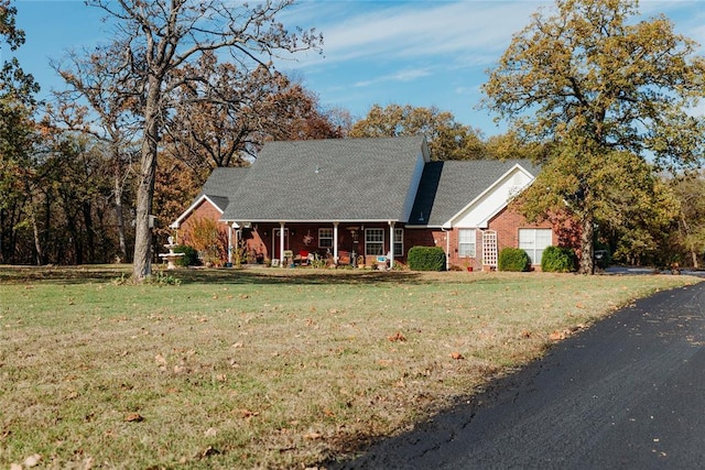 new england style home featuring a front yard