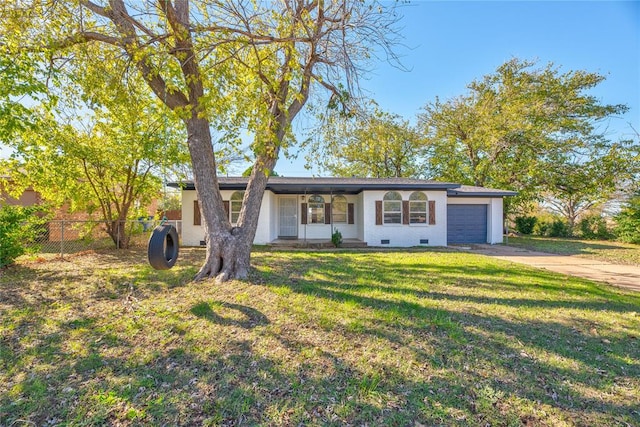 ranch-style home with covered porch, a garage, and a front lawn