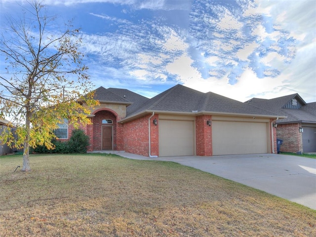 view of front of home with a front lawn and a garage