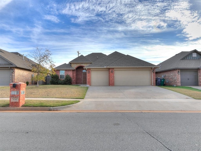 view of front of property featuring a garage and a front lawn