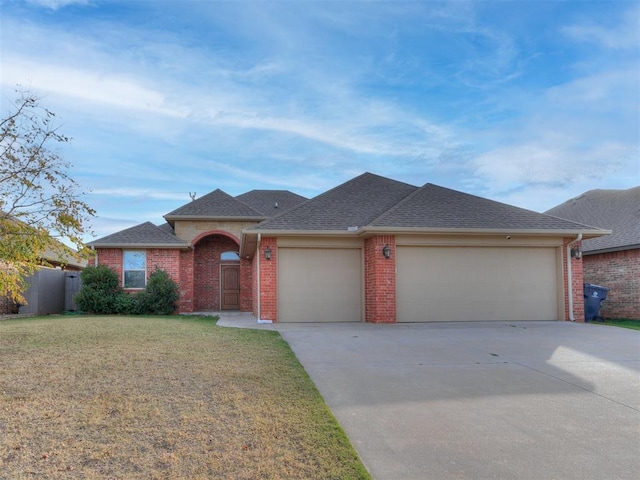 single story home featuring a garage and a front lawn