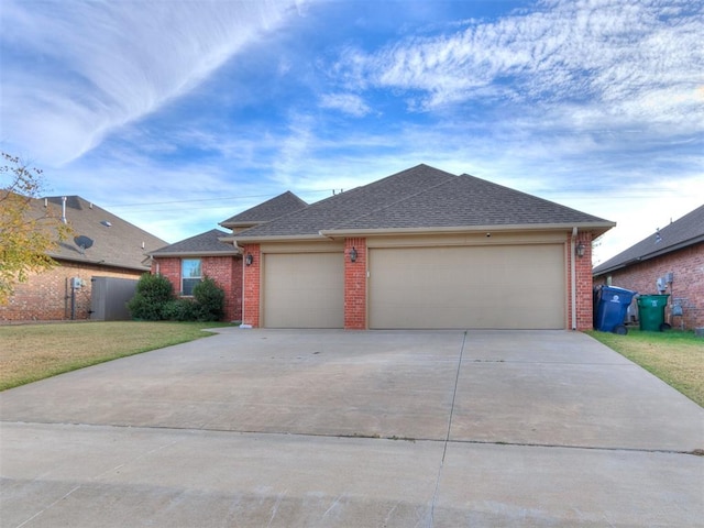 ranch-style home with a front yard and a garage