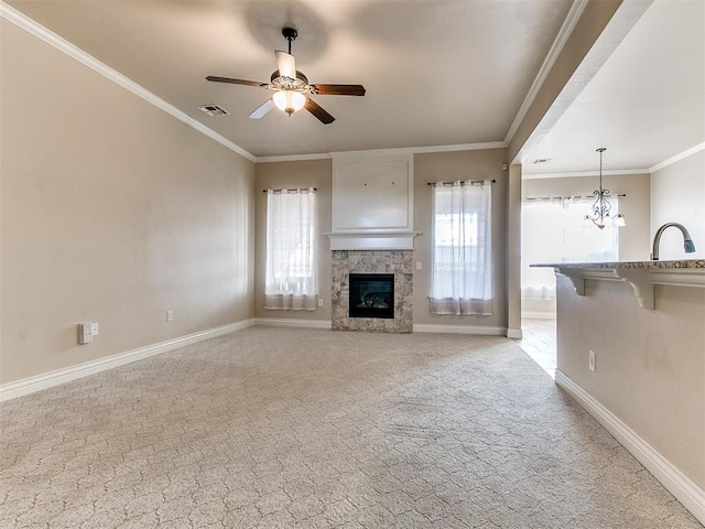 unfurnished living room with light carpet, a stone fireplace, and plenty of natural light