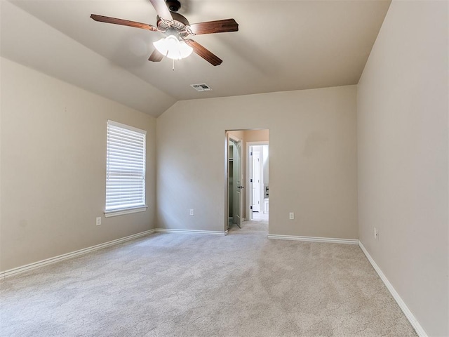 carpeted empty room featuring ceiling fan and lofted ceiling