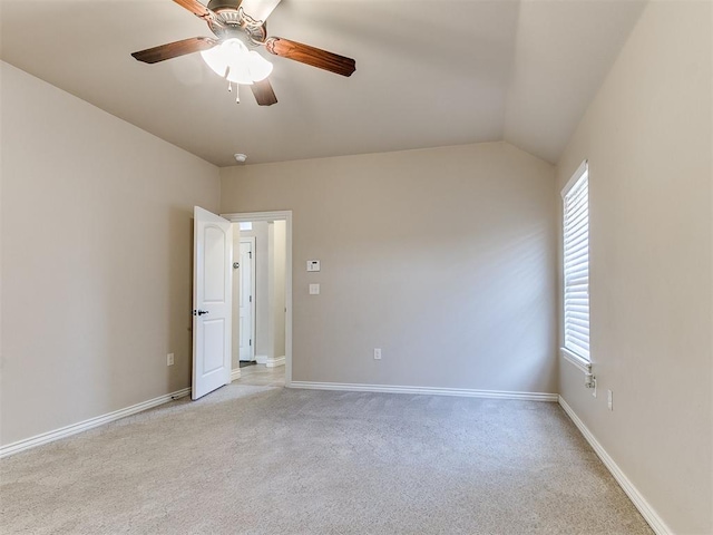 carpeted empty room with ceiling fan and lofted ceiling