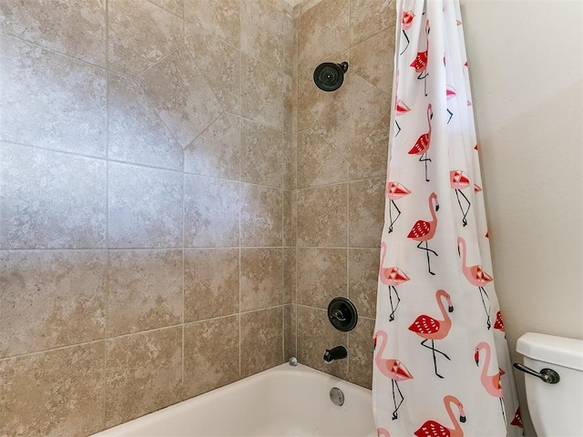 bathroom with shower / bath combination with curtain and toilet