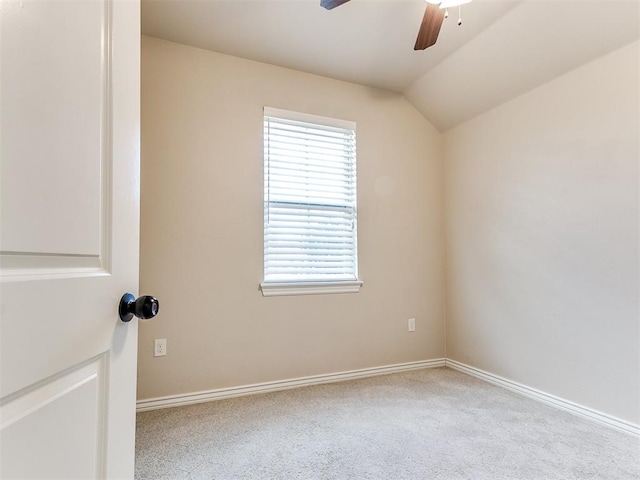 carpeted empty room featuring ceiling fan and lofted ceiling