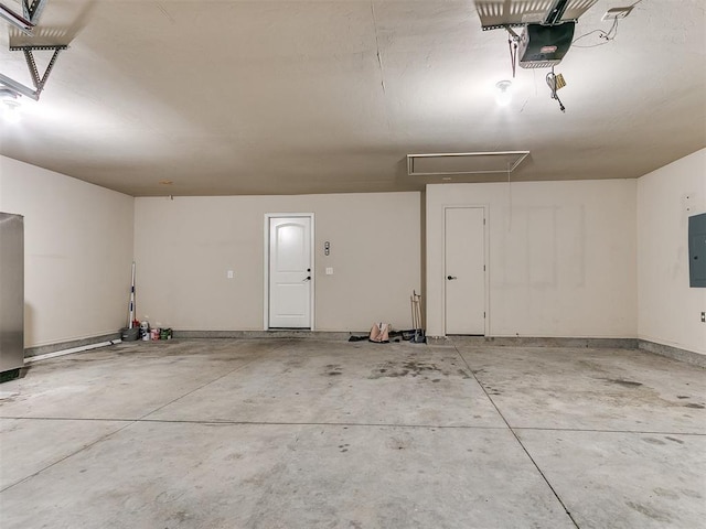 garage featuring electric panel and a garage door opener