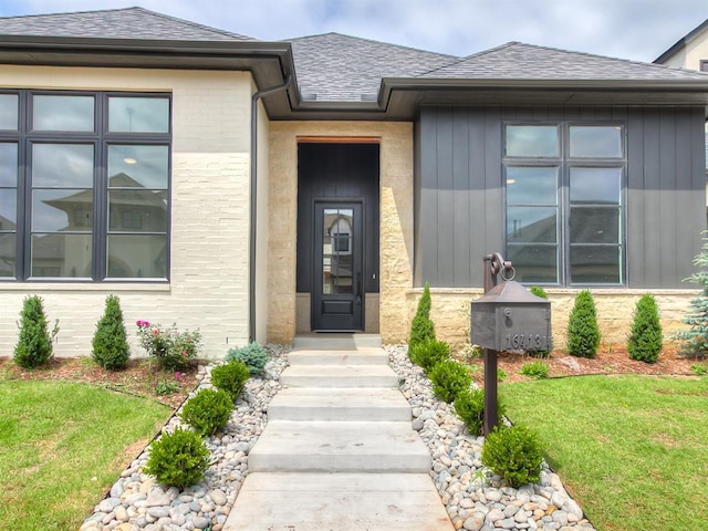 16413 Burgundy E Dr, Edmond, OK 73013 - property entrance featuring a shingled roof and a lawn