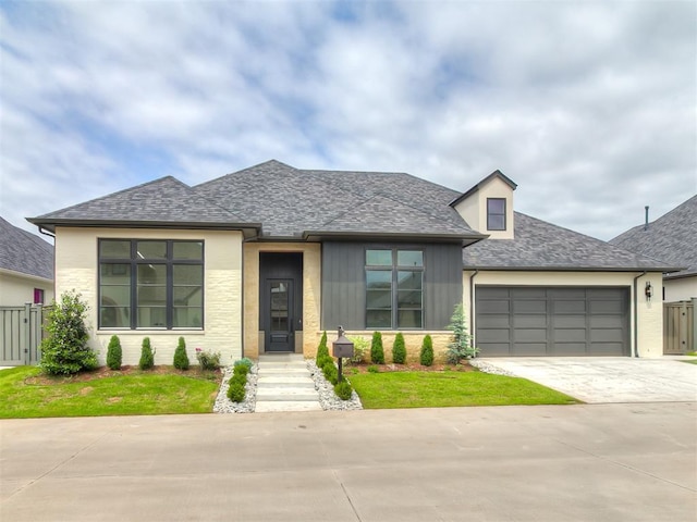 16413 Burgundy E Dr, Edmond, OK 73013 - view of front facade with driveway, an attached garage, a shingled roof, and brick siding
