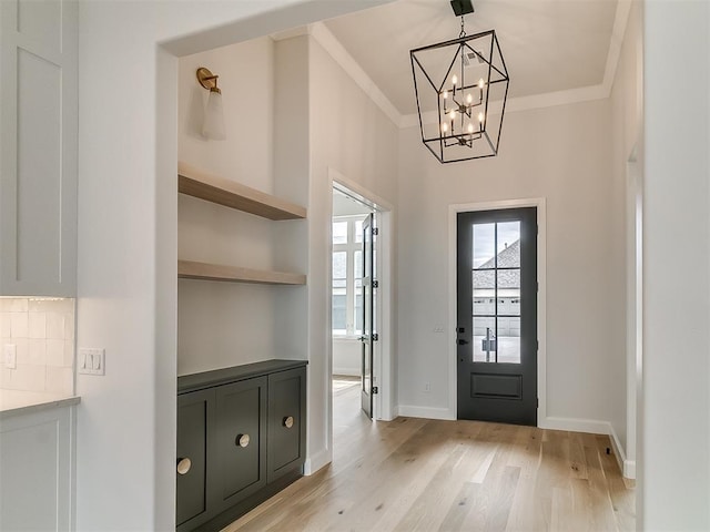 16413 Burgundy E Dr, Edmond, OK 73013 - entryway with a chandelier, light wood-type flooring, crown molding, and baseboards