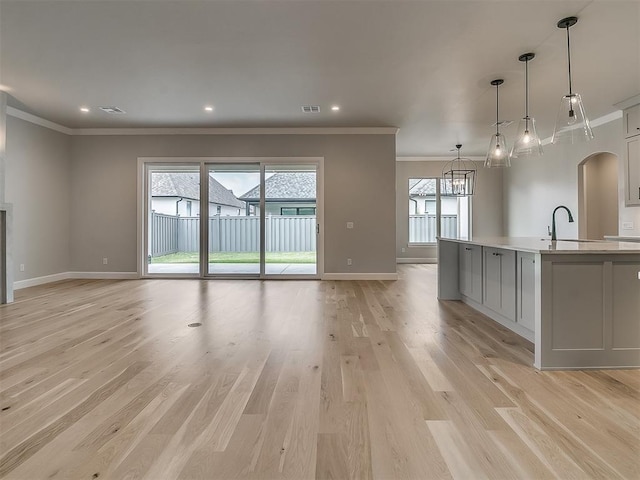 16413 Burgundy E Dr, Edmond, OK 73013 - unfurnished living room with ornamental molding, baseboards, a sink, light wood finished floors, and recessed lighting