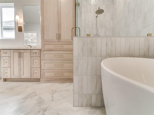 16413 Burgundy E Dr, Edmond, OK 73013 - bathroom featuring marble finish flooring, a soaking tub, vanity, tiled shower, and tile walls