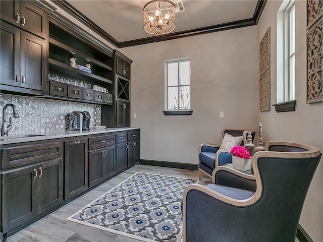 16413 Burgundy E Dr, Edmond, OK 73013 - sitting room with crown molding, light wood-style flooring, baseboards, and a chandelier