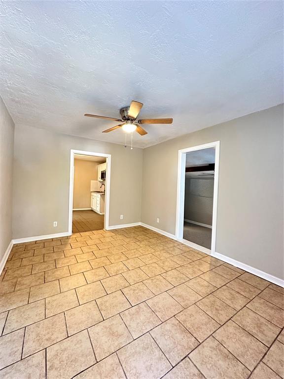 spare room featuring ceiling fan and a textured ceiling