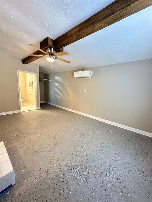 unfurnished bedroom with a textured ceiling, a wall mounted AC, ceiling fan, beamed ceiling, and a closet