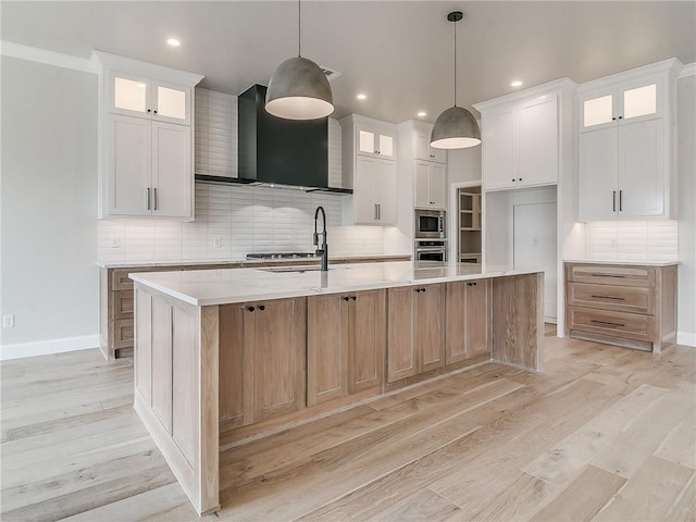 kitchen with pendant lighting, white cabinets, a spacious island, tasteful backsplash, and stainless steel appliances