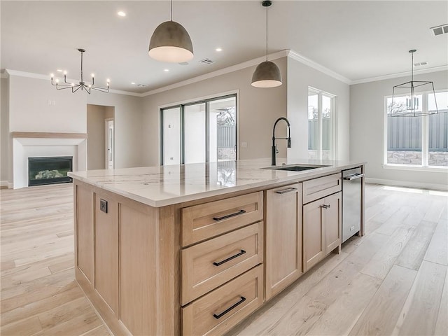 kitchen featuring pendant lighting, sink, a spacious island, and light brown cabinets