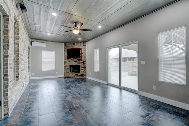 unfurnished living room with plenty of natural light, ceiling fan, a fireplace, and brick wall