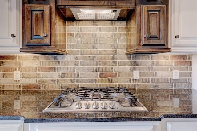 kitchen with decorative backsplash, white cabinetry, and stainless steel gas stovetop