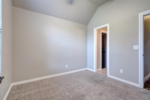 unfurnished bedroom featuring light colored carpet and lofted ceiling