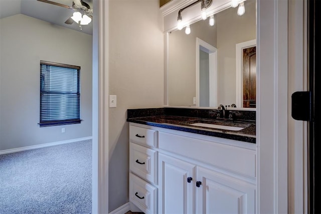 bathroom featuring vanity, ceiling fan, and lofted ceiling