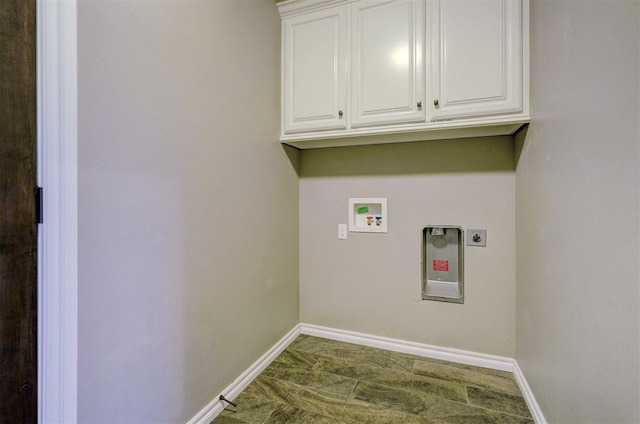 laundry room featuring electric dryer hookup, hookup for a washing machine, and cabinets