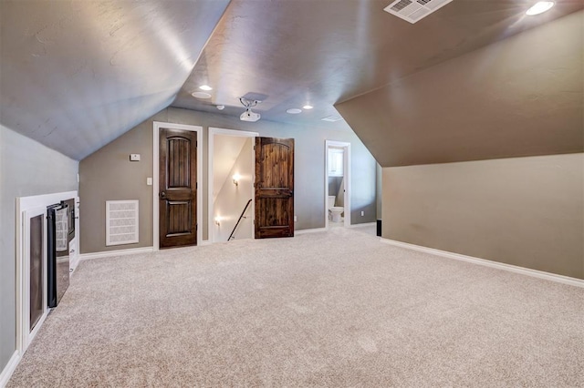 additional living space with carpet and vaulted ceiling