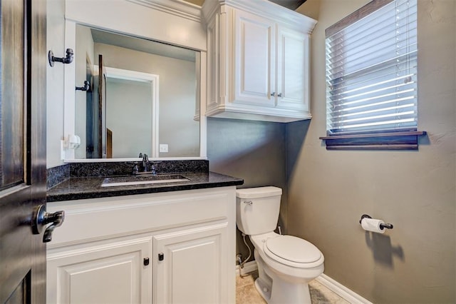 bathroom featuring tile patterned flooring, vanity, and toilet