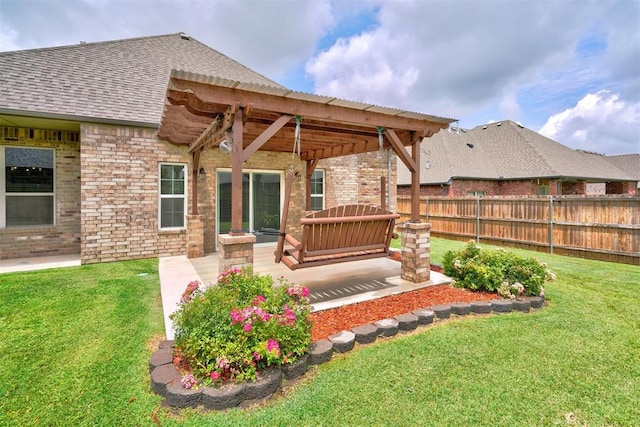 rear view of house with a yard and a pergola