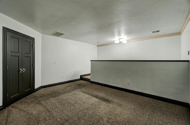 unfurnished room featuring carpet floors and a textured ceiling