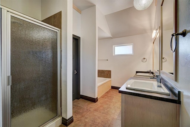 bathroom featuring plus walk in shower, vanity, lofted ceiling, and tile patterned flooring