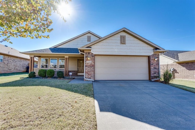 view of front of home with driveway, brick siding, a front lawn, and an attached garage