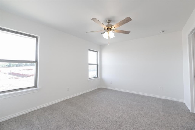 empty room featuring ceiling fan, baseboards, and carpet floors