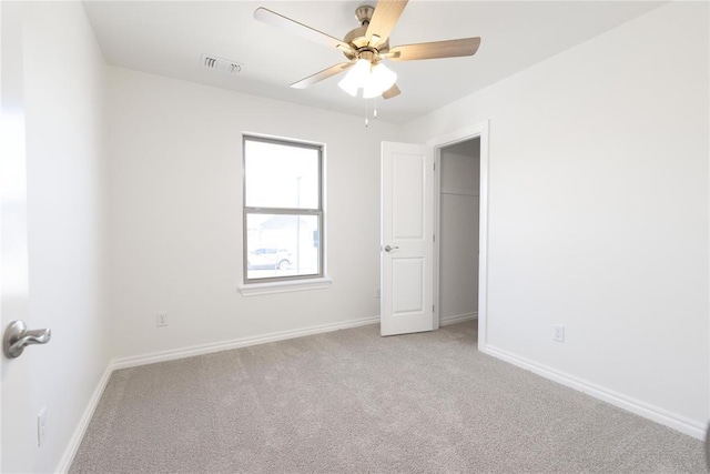 unfurnished bedroom featuring visible vents, baseboards, ceiling fan, and carpet floors