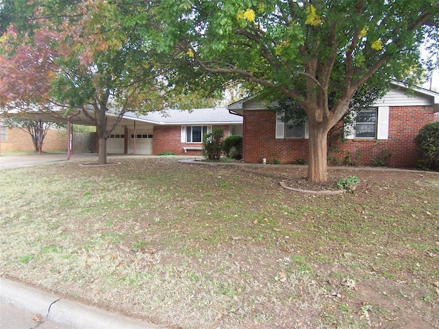 ranch-style home featuring a front yard and a carport