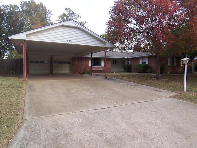 view of front facade featuring a garage, a front yard, and a carport