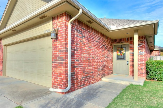 view of exterior entry featuring a garage