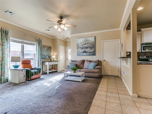 living room with crown molding, light tile patterned floors, and ceiling fan