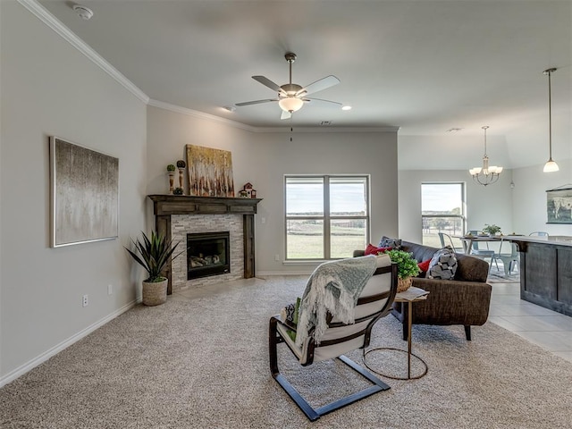 living room with ceiling fan with notable chandelier, a stone fireplace, light colored carpet, and ornamental molding