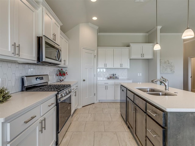 kitchen featuring white cabinets, hanging light fixtures, sink, and appliances with stainless steel finishes